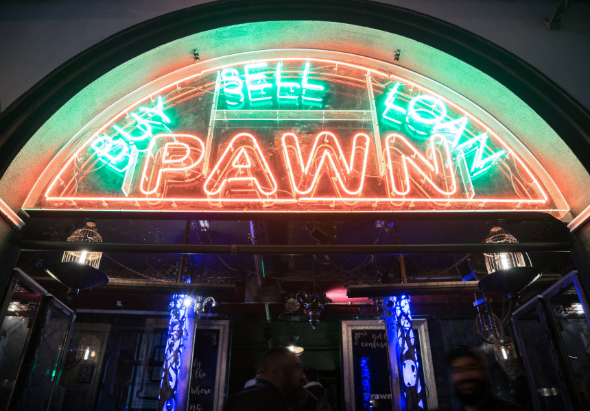 The glowing Buy Sell Loan Pawn neon entrance at Pawn and Co Melbourne